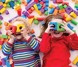 Children playing with blocks on the floor