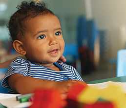 Infant & Toddler Program: Toddler with a smile on his face