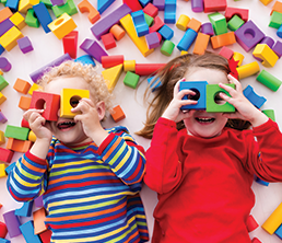 Preschool Program: Two kids playing with blocks